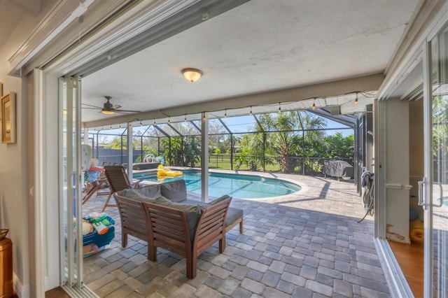 view of swimming pool featuring a patio area and a lanai