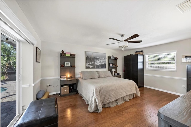 bedroom featuring access to outside, ceiling fan, and dark hardwood / wood-style floors