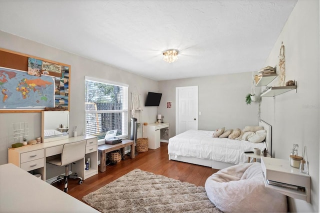 bedroom with dark hardwood / wood-style flooring