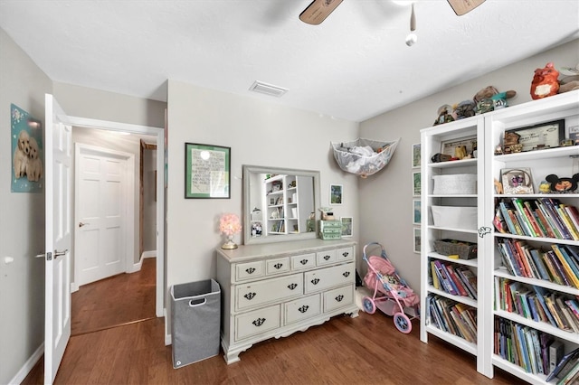 interior space featuring ceiling fan and dark hardwood / wood-style flooring