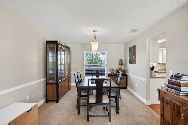 dining room with light carpet