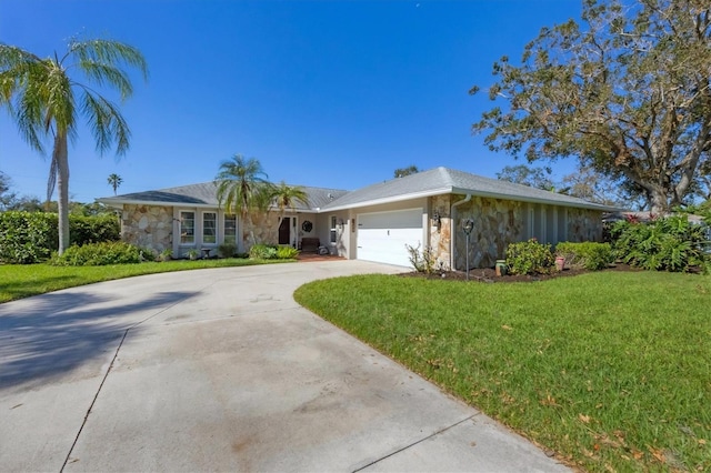 ranch-style home with a garage and a front lawn