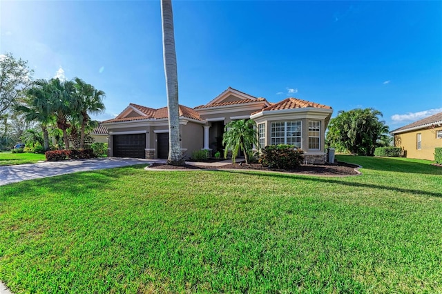 mediterranean / spanish house with a garage and a front yard