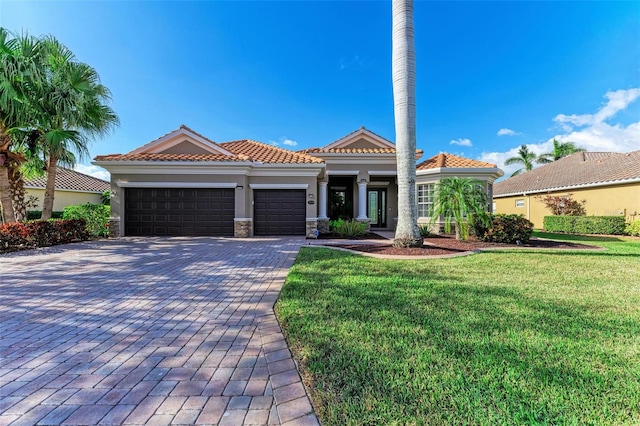 mediterranean / spanish-style house with a front lawn and a garage