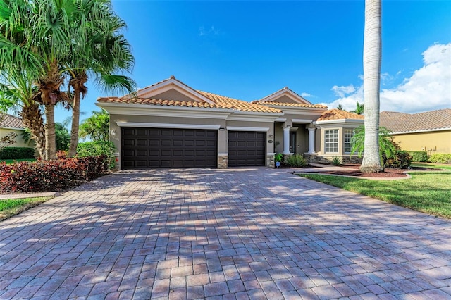 mediterranean / spanish home featuring a garage