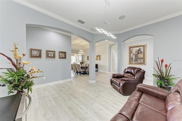 living room with light hardwood / wood-style flooring and crown molding