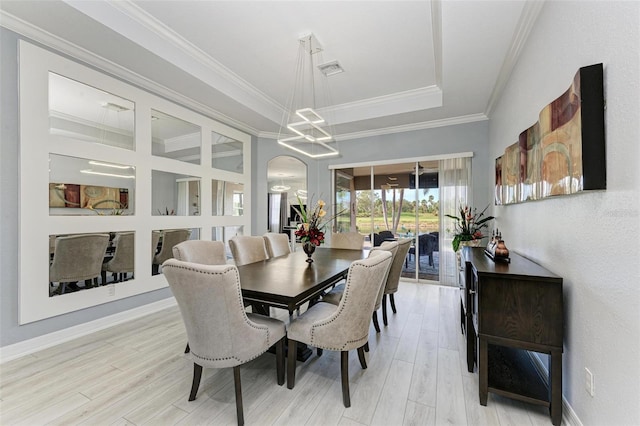 dining area featuring light wood-type flooring and ornamental molding