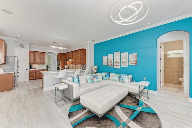 living room featuring light wood-type flooring and crown molding