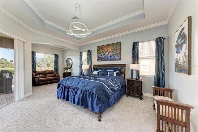 bedroom featuring a tray ceiling, crown molding, a notable chandelier, carpet floors, and access to outside