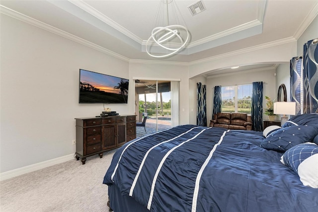 carpeted bedroom with access to exterior, multiple windows, a raised ceiling, and crown molding