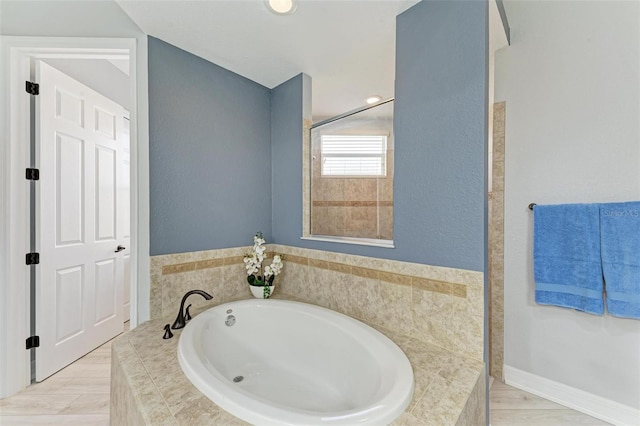 bathroom featuring tiled tub