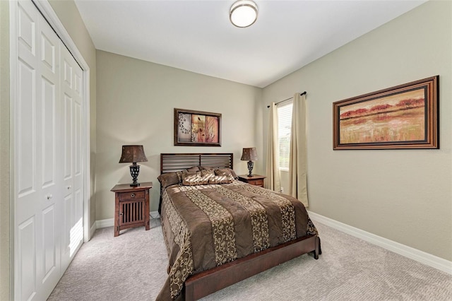 bedroom with light carpet and a closet