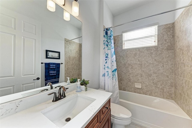 full bathroom with shower / tub combo with curtain, vanity, and toilet