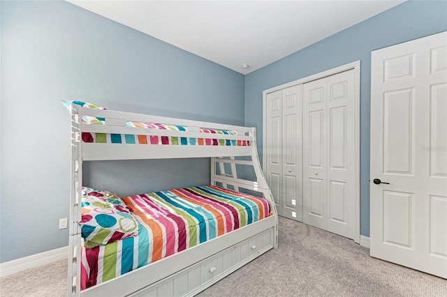 bedroom with light colored carpet and a closet