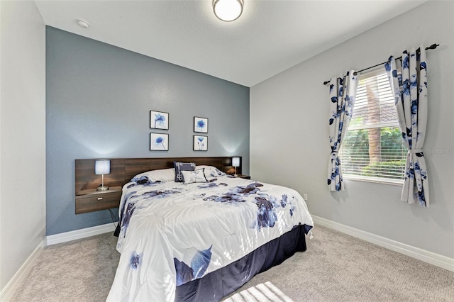 bedroom featuring vaulted ceiling and carpet flooring