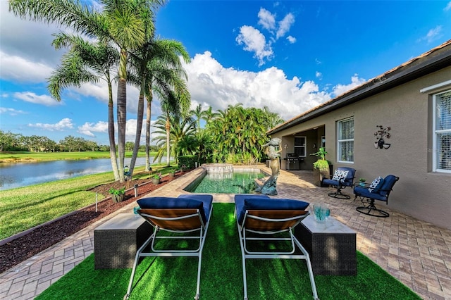 view of pool featuring a yard, a water view, and a patio area