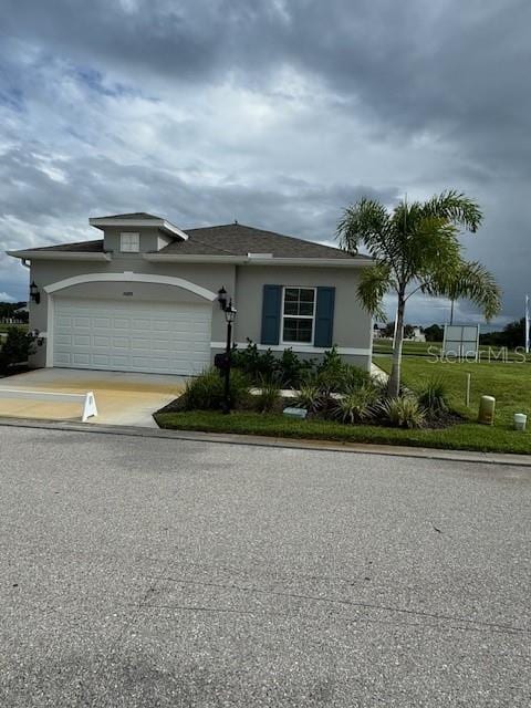 view of front of property with a garage and a front yard