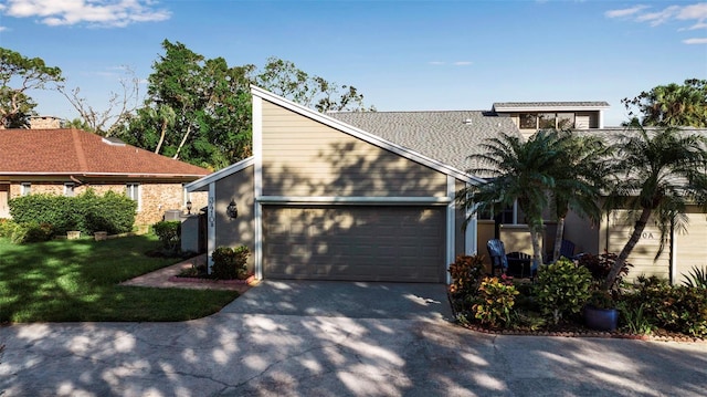 view of front of home featuring a garage and a front yard