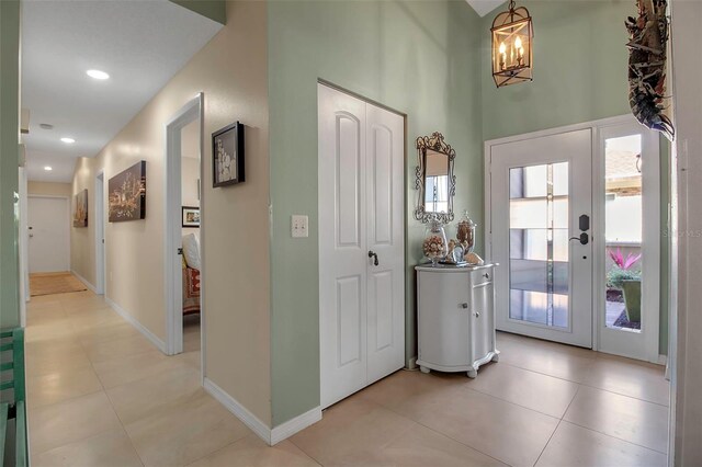 3410 Avenida Madera Unit B, Bradenton, FL 34210 - entrance foyer featuring a chandelier, light tile patterned floors, baseboards, a towering ceiling, and recessed lighting