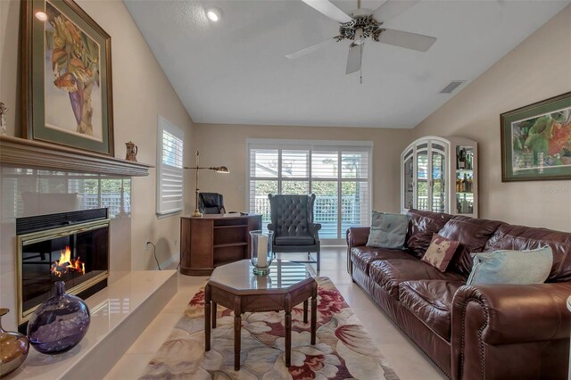 3410 Avenida Madera Unit B, Bradenton, FL 34210 - living room with lofted ceiling, a tiled fireplace, a ceiling fan, an office area, and light tile patterned floors
