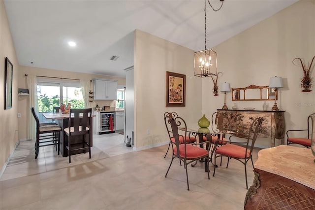 dining room with vaulted ceiling, wine cooler, and a notable chandelier