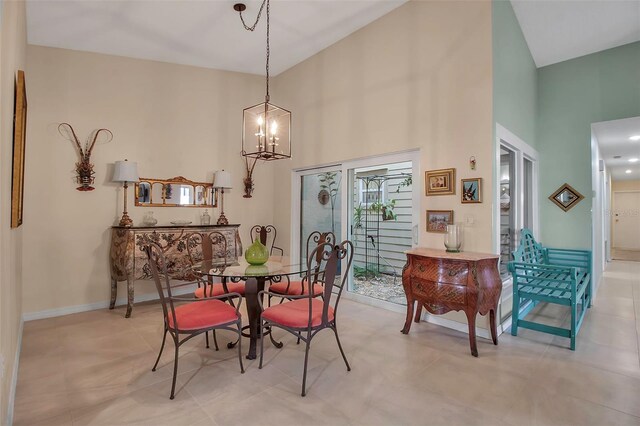 3410 Avenida Madera Unit B, Bradenton, FL 34210 - dining room with a towering ceiling, a chandelier, and baseboards