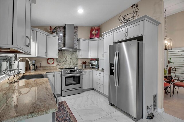 3410 Avenida Madera Unit B, Bradenton, FL 34210 - kitchen featuring wall chimney range hood, stainless steel appliances, a sink, light stone countertops, and backsplash