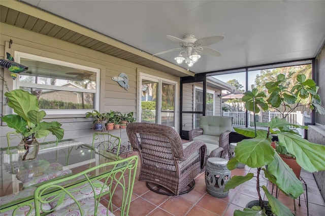 sunroom / solarium featuring ceiling fan