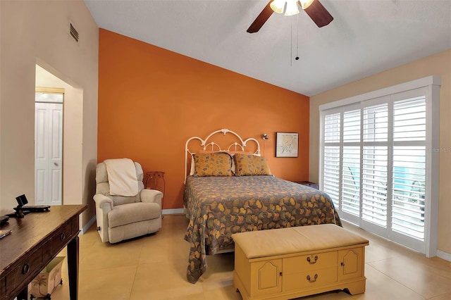 tiled bedroom featuring ceiling fan and lofted ceiling