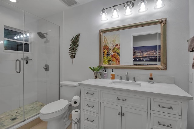 bathroom with vanity, toilet, and walk in shower