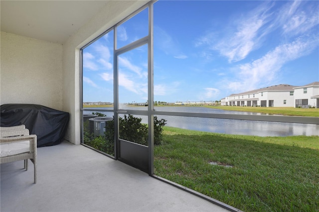 unfurnished sunroom with a water view