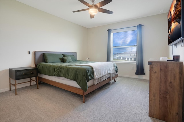 bedroom featuring light colored carpet and ceiling fan