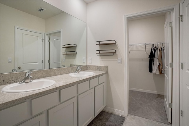 bathroom with tile patterned flooring and vanity