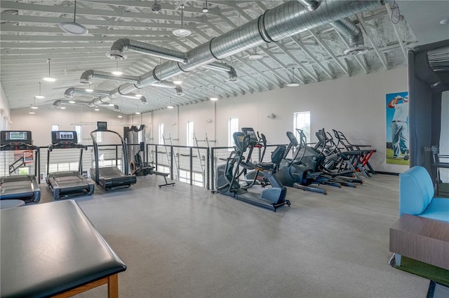 workout area with high vaulted ceiling