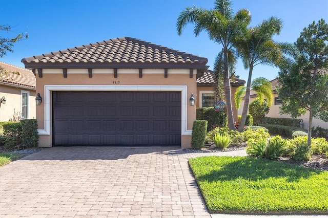 mediterranean / spanish home with a garage