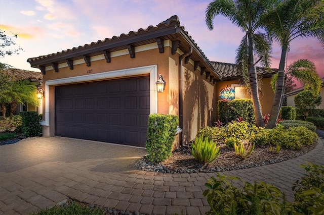 mediterranean / spanish home featuring a garage