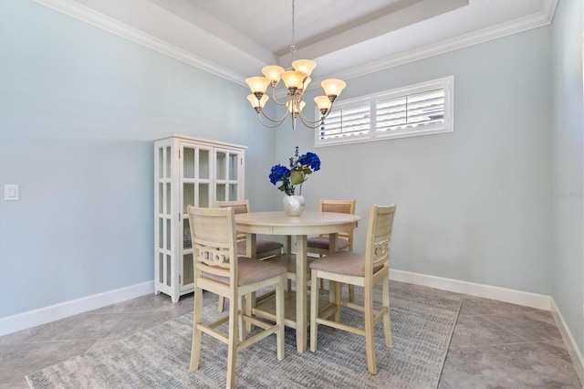 dining room with a chandelier, tile patterned floors, a raised ceiling, and ornamental molding