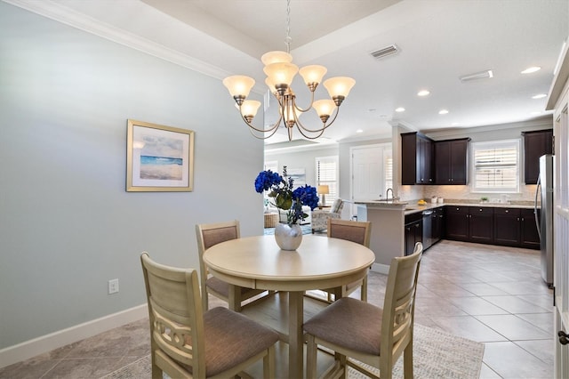 dining space with light tile patterned floors, a chandelier, and ornamental molding