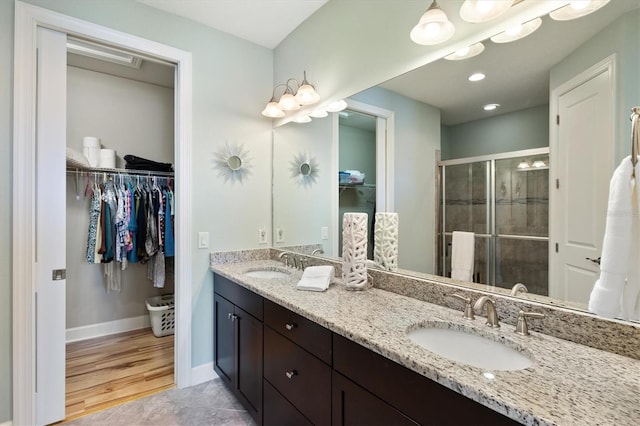 bathroom with vanity, hardwood / wood-style flooring, and an enclosed shower