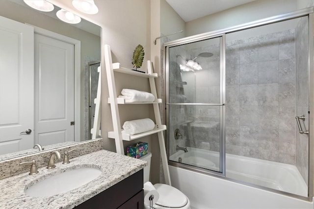 full bathroom with vanity, toilet, and shower / bath combination with glass door