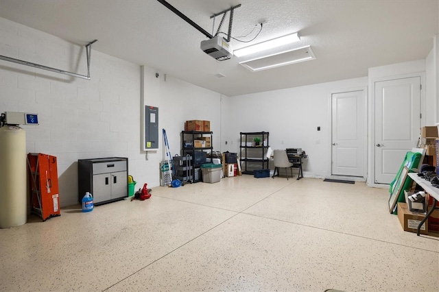 garage with a garage door opener and electric panel