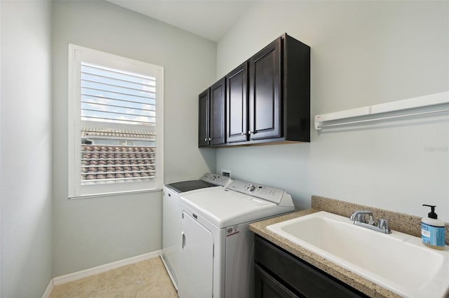 laundry room featuring cabinets, washing machine and dryer, sink, and light tile patterned flooring