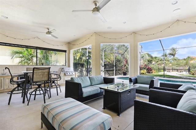 sunroom / solarium featuring ceiling fan