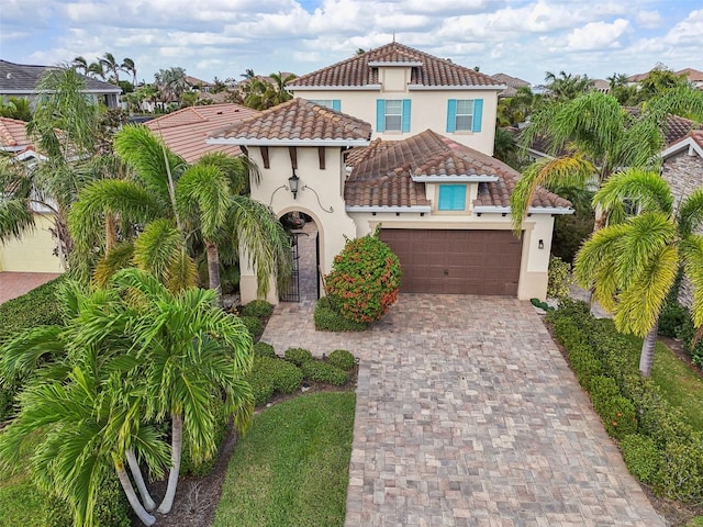 mediterranean / spanish-style home with a garage