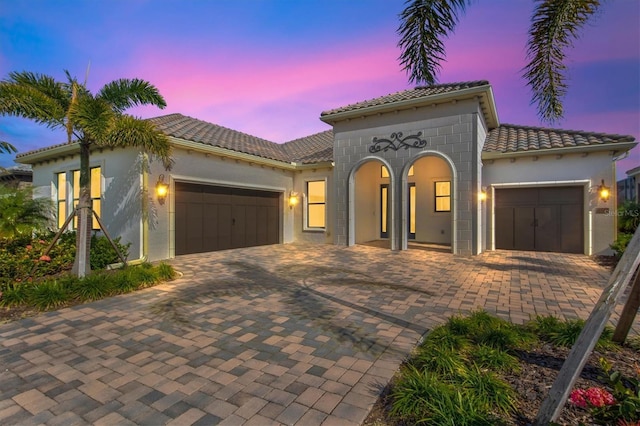 mediterranean / spanish-style home featuring a garage