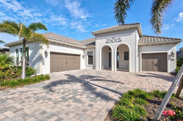 mediterranean / spanish house featuring a garage