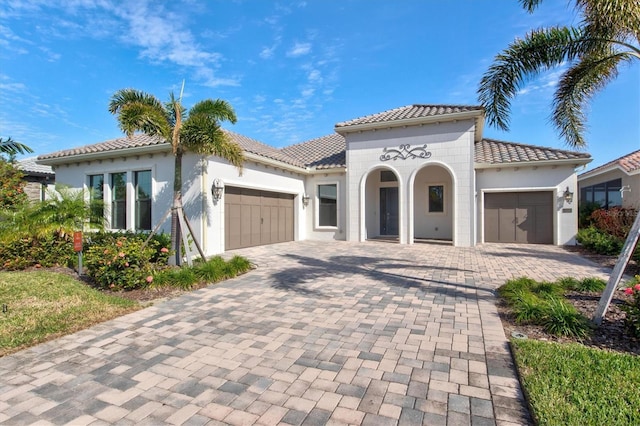 mediterranean / spanish-style house with a garage