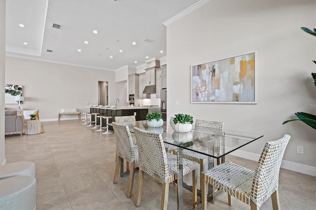 dining space featuring crown molding