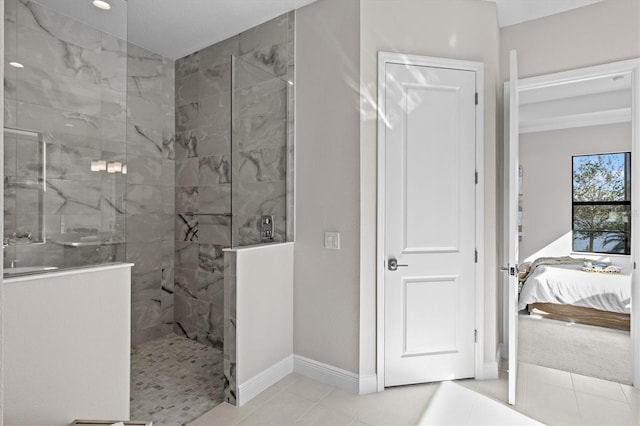 bathroom with tile patterned flooring and tiled shower