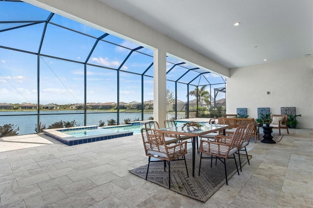 view of patio with a lanai, a swimming pool with hot tub, and a water view